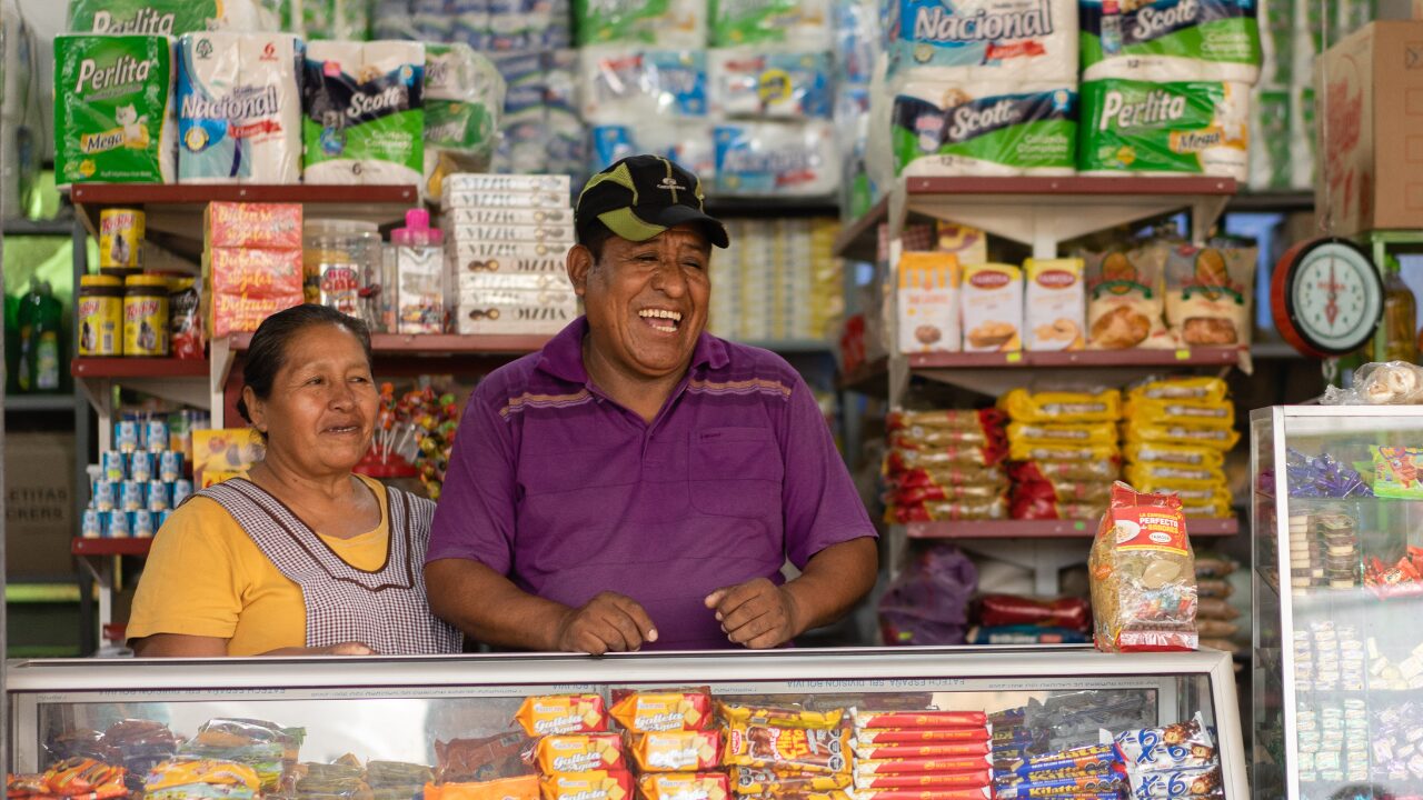 Constantino and his wife stand in their store