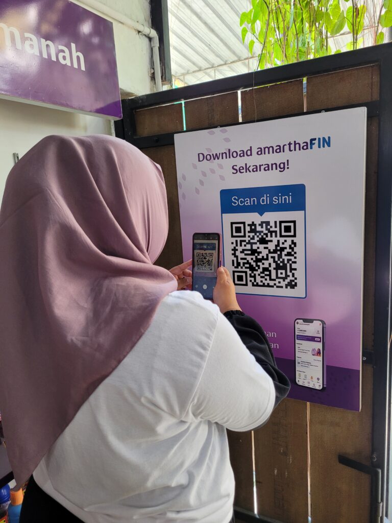 A woman scanning a QR code from a poster with the mobile phone. 