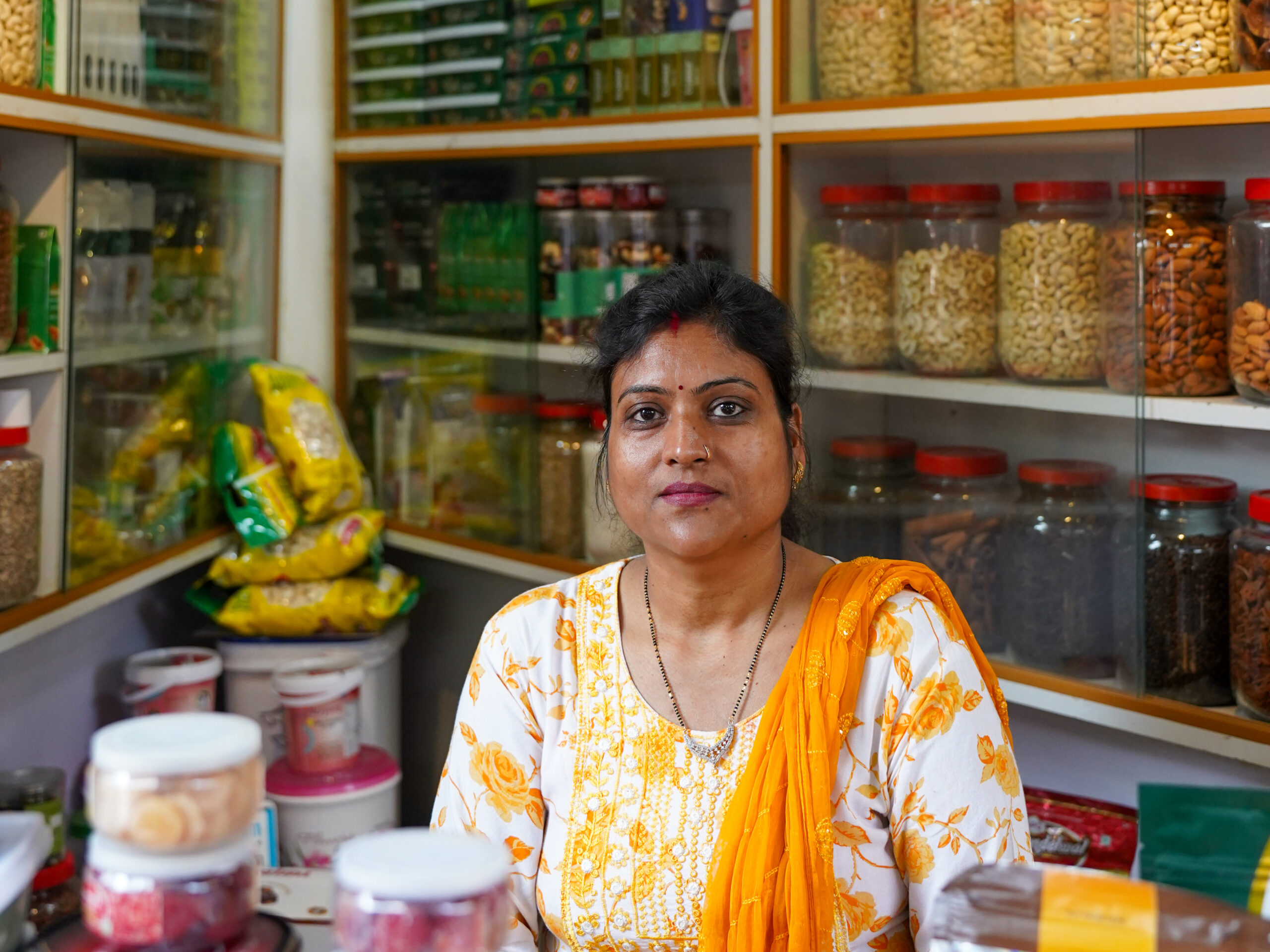 A women standing in her grocery store.