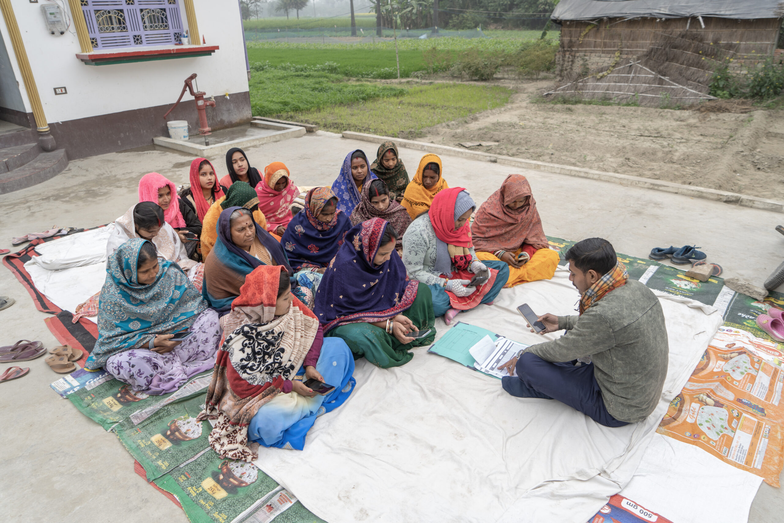 A group of women receiving training on using mobile for payments.  