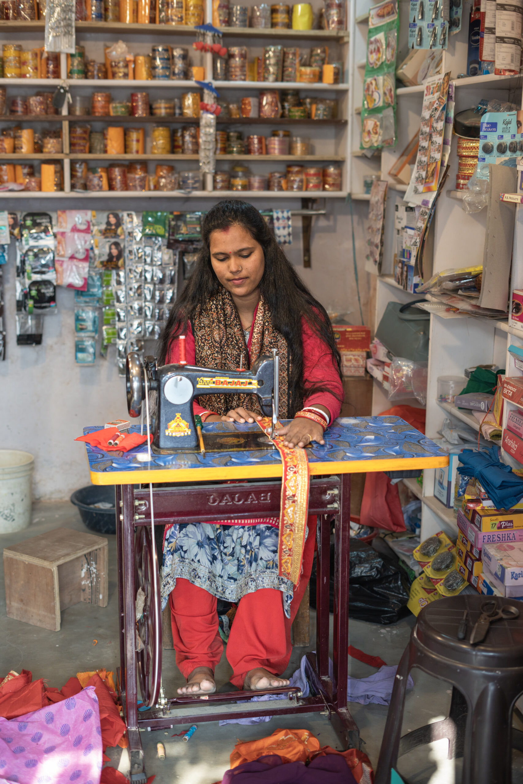 A woman using a sewing machine.