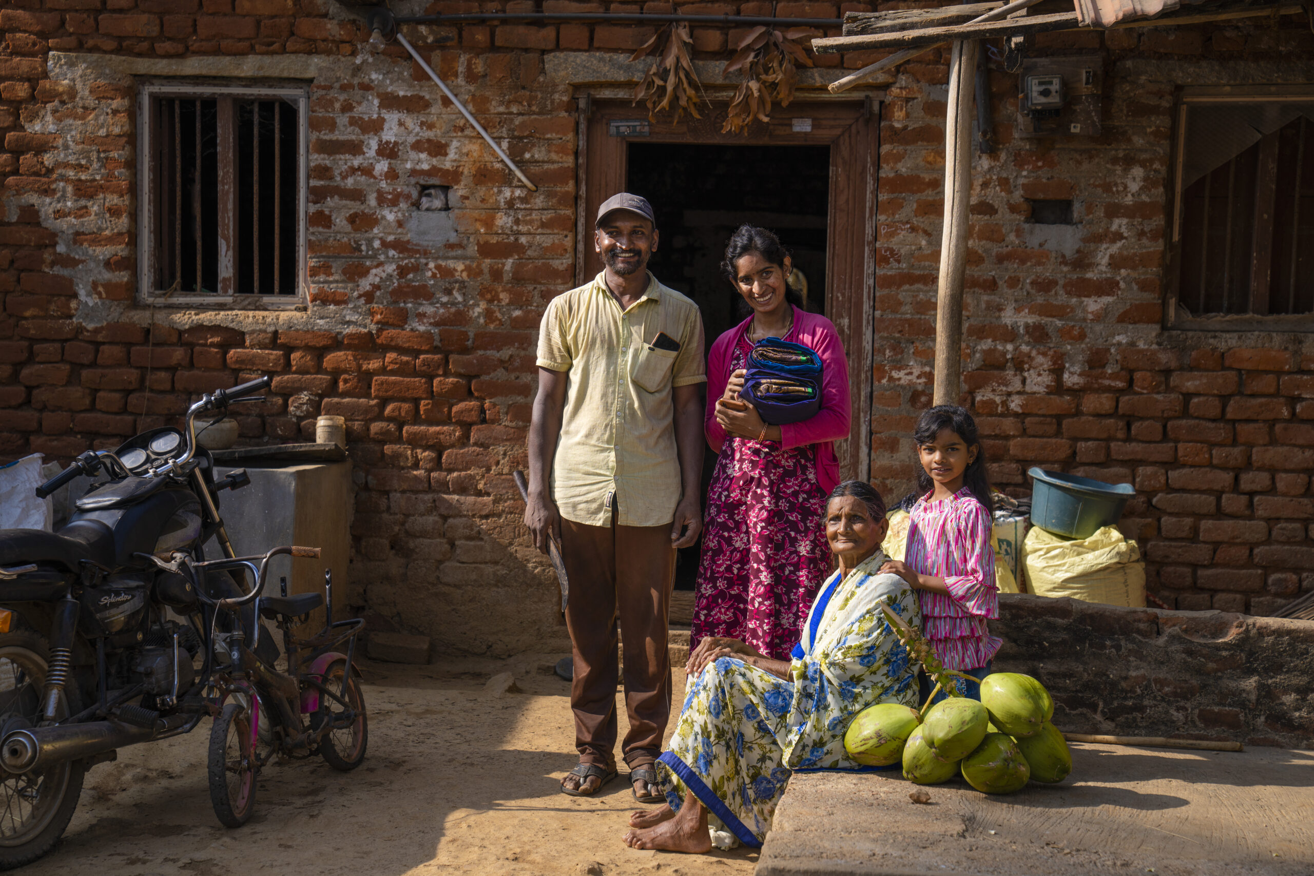 A family standing outside their half-constructed house.