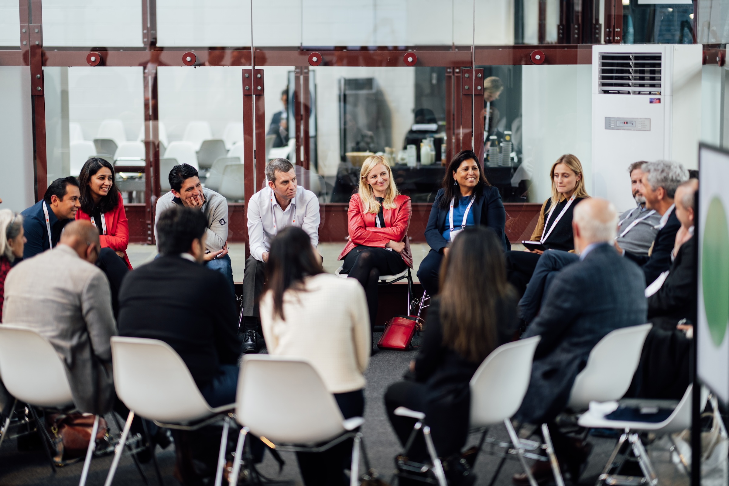 people sit in a circle to discuss during the Summit