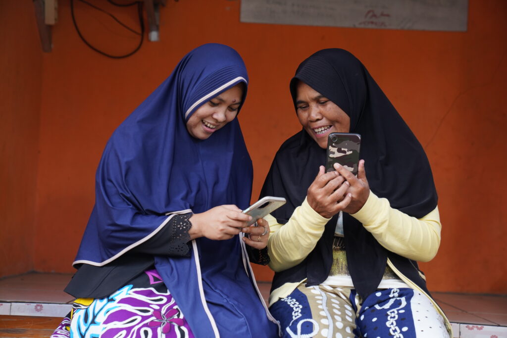 Two women using their phones.