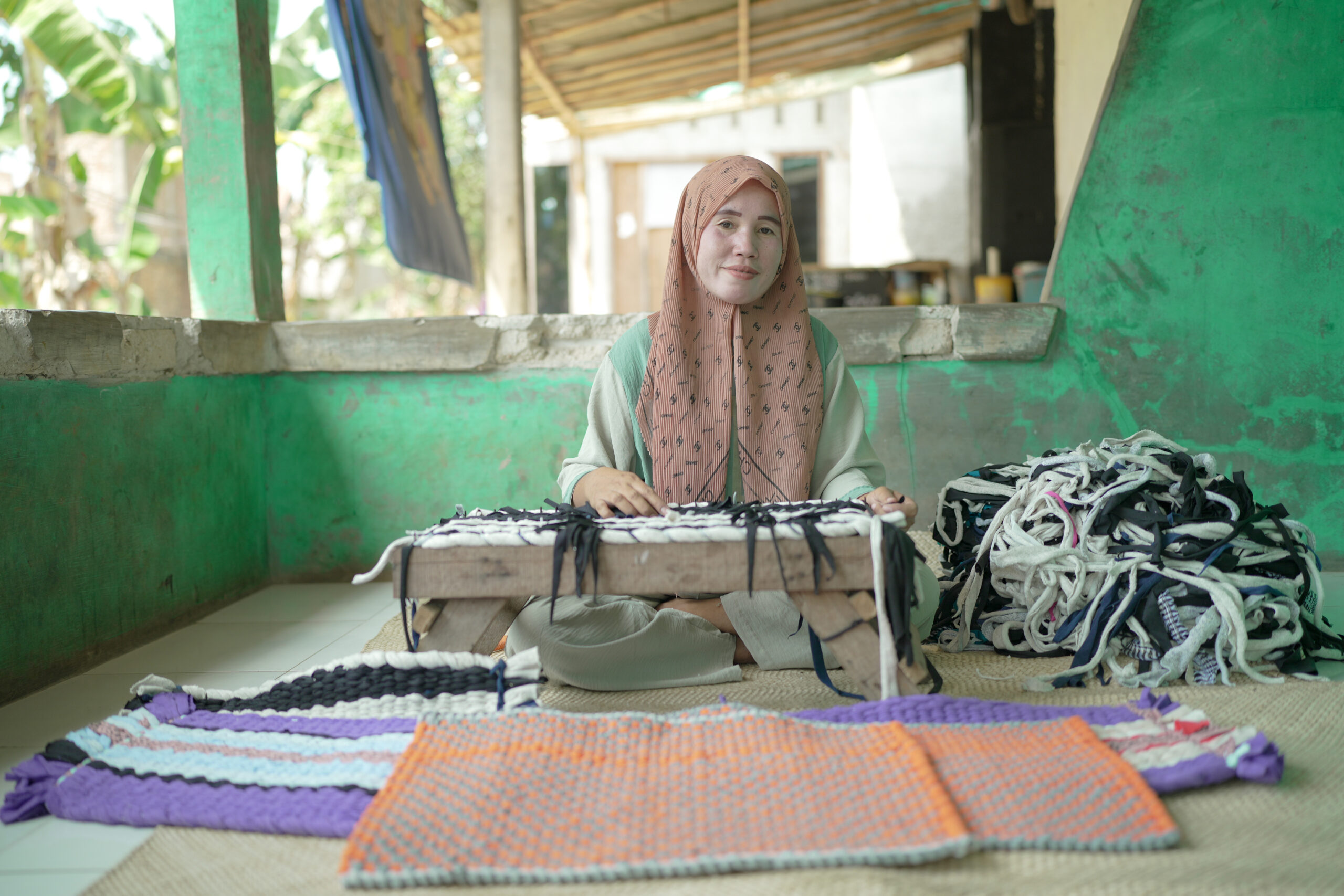 A woman using a sewing machine. 