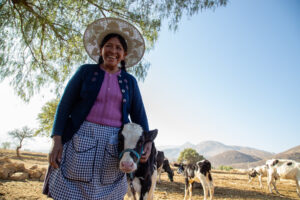 Sulema with one of her cows on her farm in Bolivia