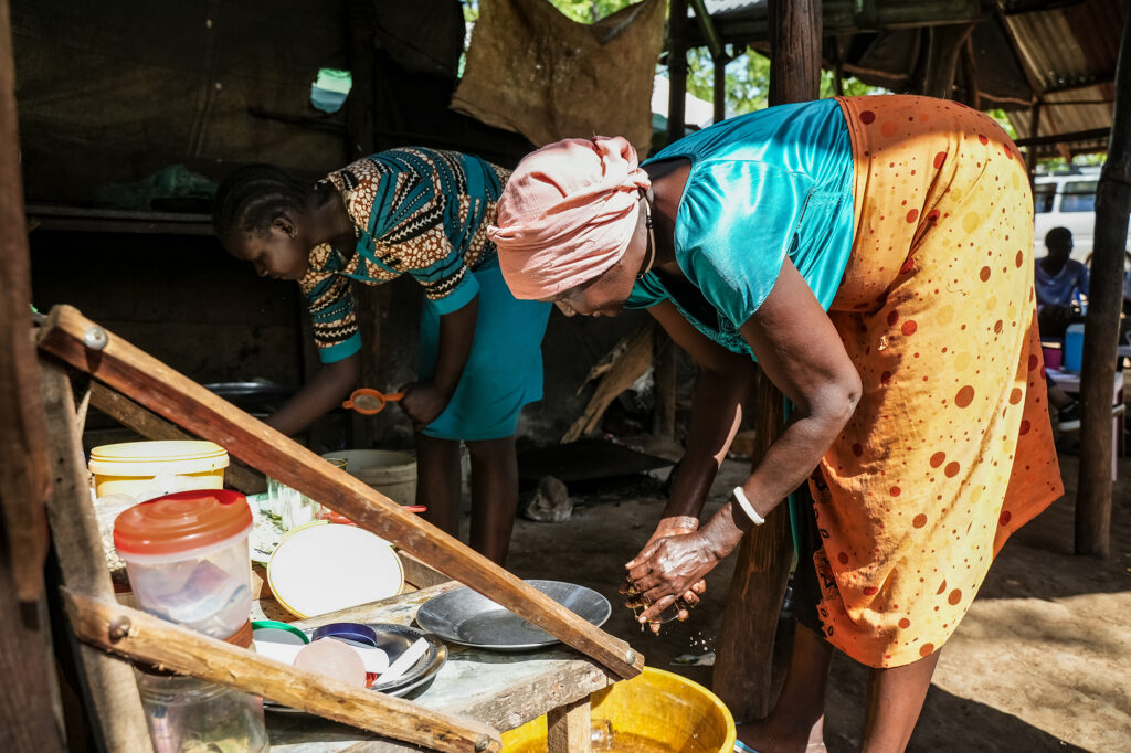 Mer Guek works at her cafe in a refugee settlement in Ethiopia