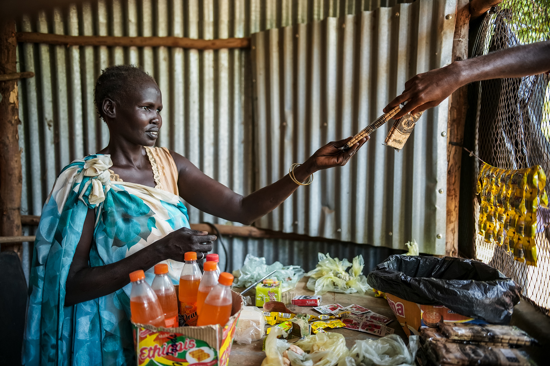 Nya works at her small store in a refugee settlement in Ethiopia